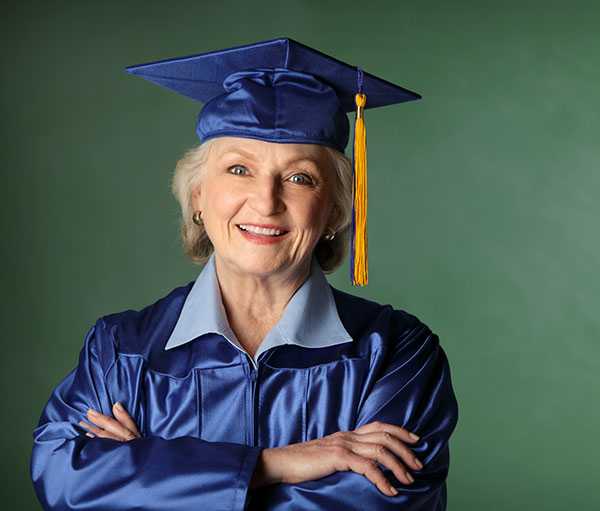 senior woman in graduation cap and gown